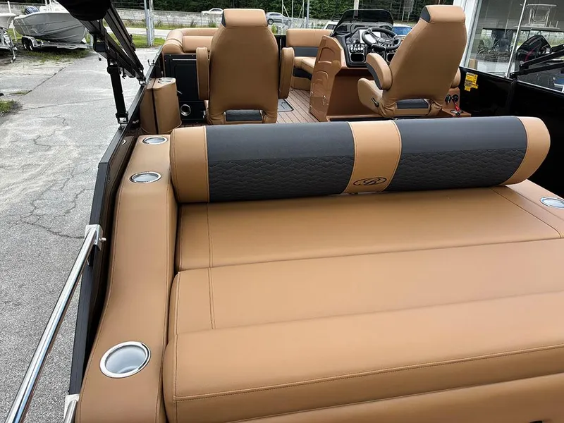 Slide: The Image of 2025 Bentley Pontoons Elite 253 Swingback Tritoon with luxurious tan seating and dual captain chairs. - 11