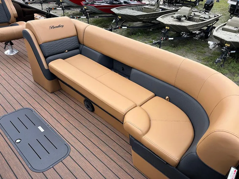 Slide: The Image of 2025 Bentley Pontoons Elite 253 Swingback interior with tan and gray seating on a tritoon boat. - 12