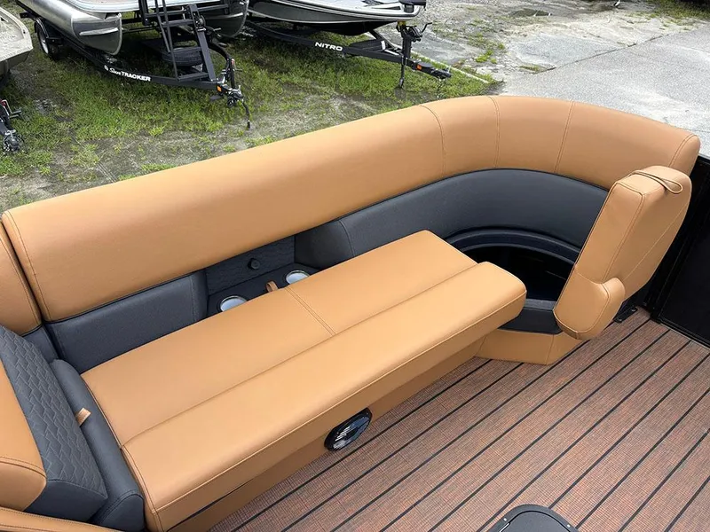 Slide: The Image of 2025 Bentley Pontoons Elite 253 Swingback interior with tan and gray seating on a tritoon boat. - 14
