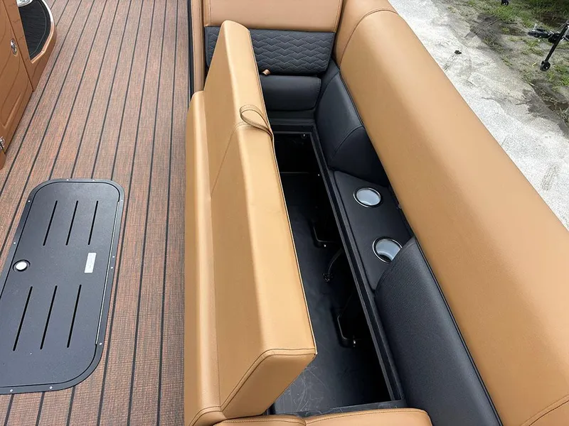 Slide: The Image of 2025 Bentley Pontoons Elite 253 Swingback interior with tan and black seating, cup holders. - 15