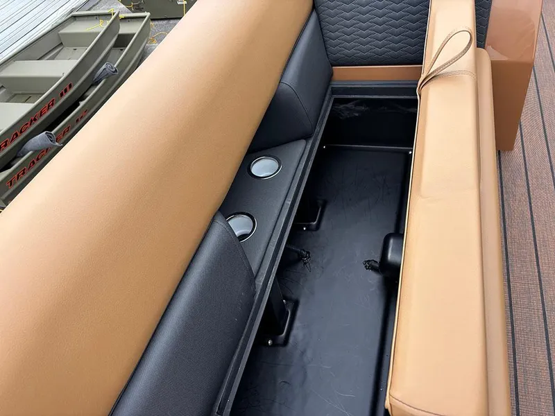 Slide: The Image of 2025 Bentley Pontoons Elite 253 interior seating with tan and black upholstery, cup holders visible. - 18