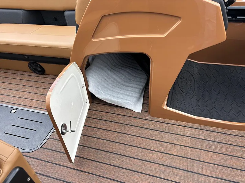 Slide: The Image of 2025 Bentley Pontoons Elite 253 interior storage compartment with open door, showcasing sleek design. - 22