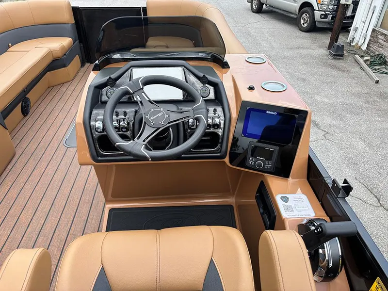 Slide: The Image of 2025 Bentley Pontoons Elite 253 Swingback Dual Captain Full Tritoon dashboard with steering wheel and controls. - 23