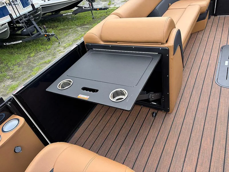Slide: The Image of 2025 Bentley Pontoons Elite 253 interior with fold-out table and cup holders. - 25