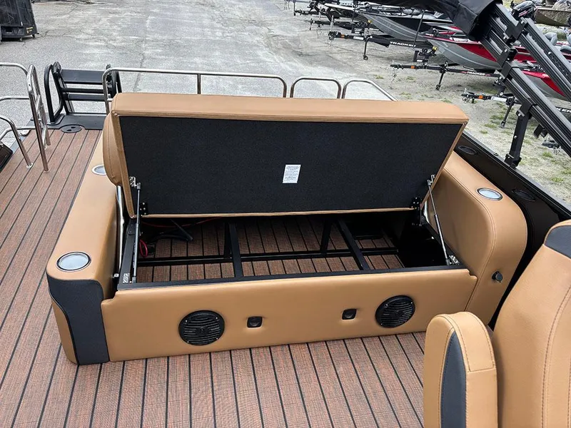 Slide: The Image of 2025 Bentley Pontoons Elite 253 Swingback Tritoon with open storage compartment and tan seating. - 27