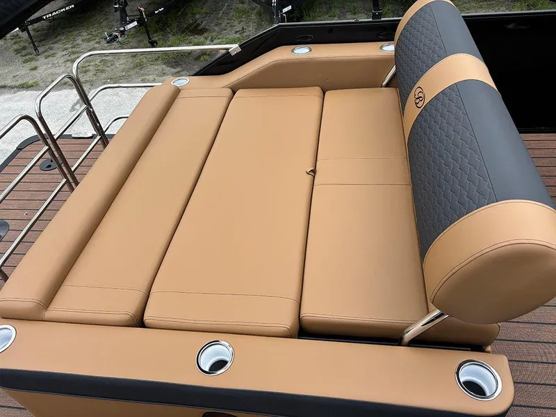 Slide: The Image of 2025 Bentley Pontoons Elite 253 Swingback Tritoon with luxurious tan seating and cup holders. - 28
