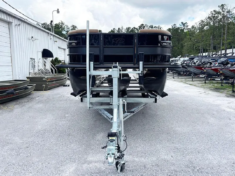 Slide: The Image of 2025 Bentley Pontoons Elite 253 Swingback Dual Captain Full Tritoon on trailer, front view. - 3