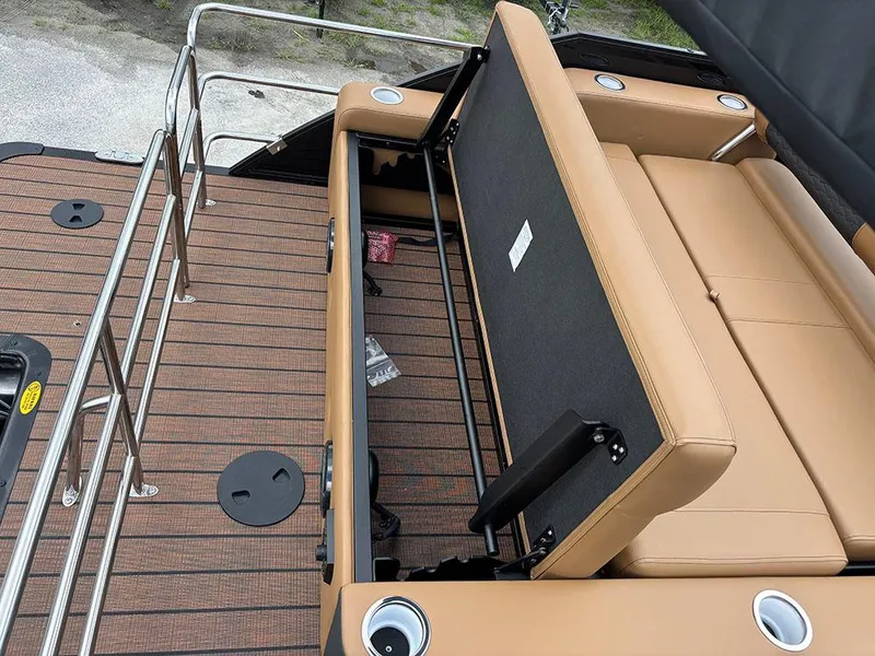 Slide: The Image of 2025 Bentley Pontoons Elite 253 Swingback Tritoon with tan seating and sleek deck design. - 30