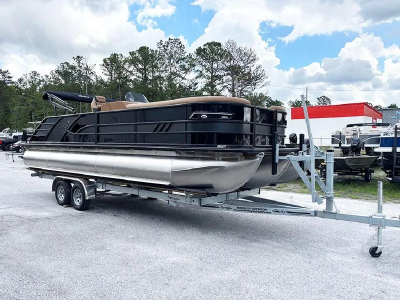 Slide: The Image of 2025 Bentley Pontoons Elite 253 Swingback Dual Captain Full Tritoon on trailer, parked outdoors. - 4