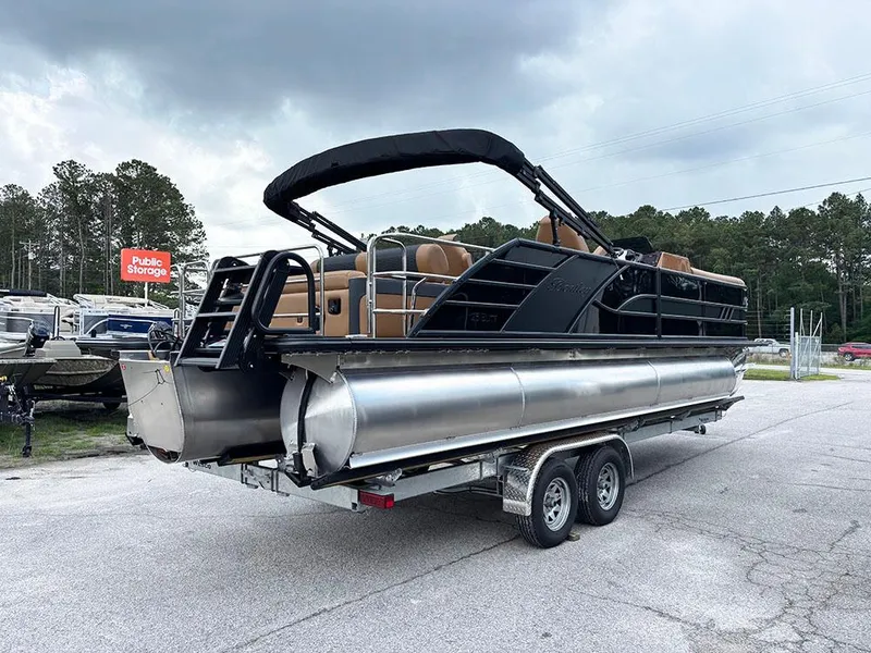 Slide: The Image of 2025 Bentley Pontoons Elite 253 Swingback Dual Captain Full Tritoon on trailer, parked outdoors. - 6