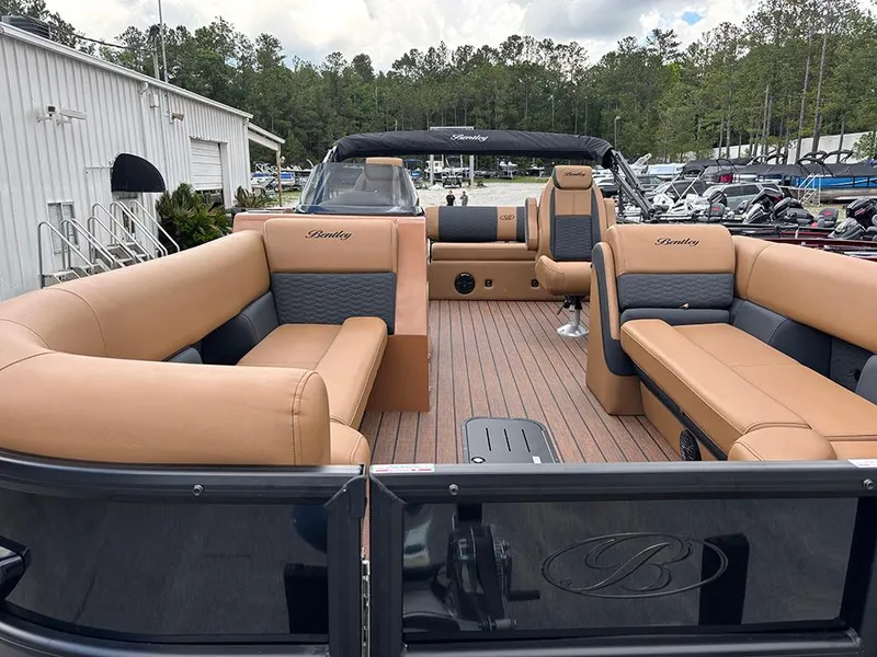 Slide: The Image of 2025 Bentley Pontoons Elite 253 Swingback Dual Captain Full Tritoon with luxurious seating and sleek design. - 9