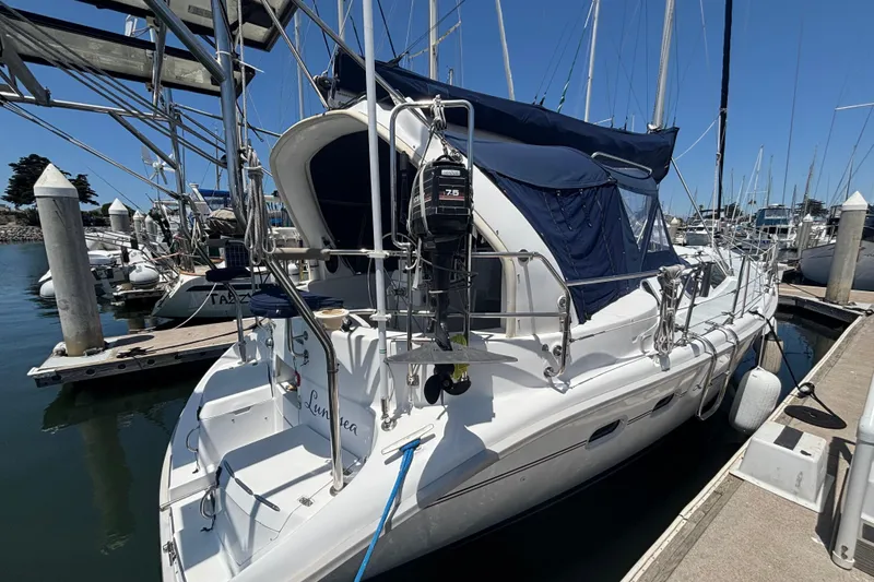 Slide: The Image of Sailboat docked at marina, 1999 Hunter 410 model with blue canopy. - 10