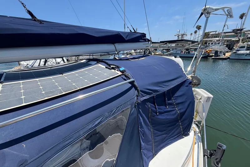 Slide: The Image of Sailboat with blue canopy and solar panels, Hunter 410 model, docked in marina, 1999. - 18