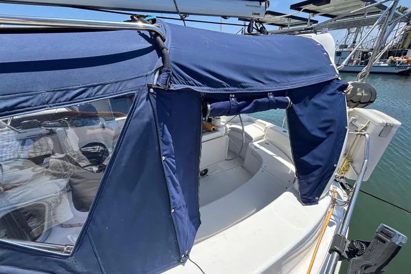 Slide: The Image of Hunter 410 sailboat cockpit with blue canvas cover, docked in marina, 1999 model. - 19