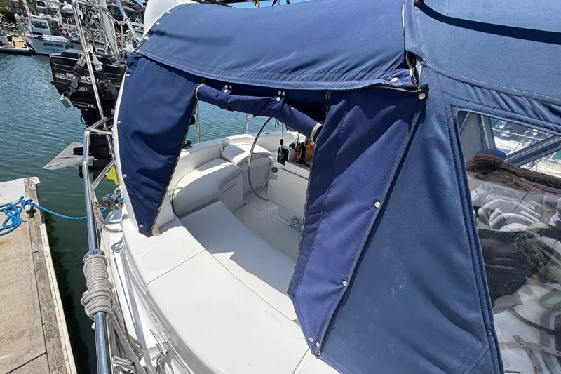 Slide: The Image of 1999 Hunter 410 sailboat with blue canopy docked at marina. - 20