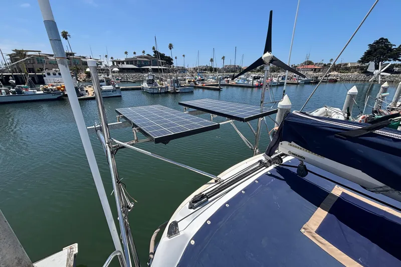 Slide: The Image of Sailboat with solar panels and wind turbine in marina, Hunter 410, 1999 model. - 21