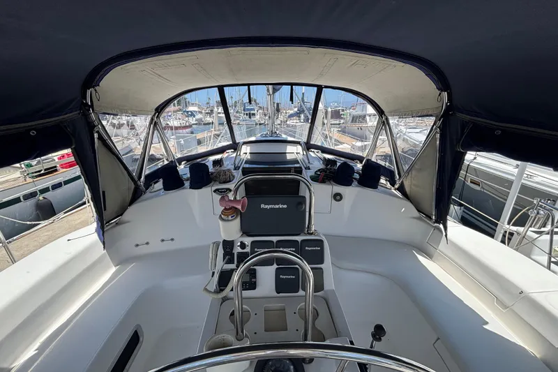 Slide: The Image of Cockpit view of a 1999 Hunter 410 sailboat docked at a marina. - 22