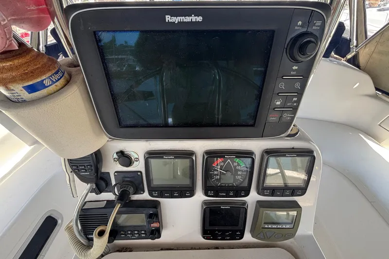 Slide: The Image of Cockpit navigation instruments on a 1999 Hunter 410 sailboat, featuring Raymarine displays. - 23