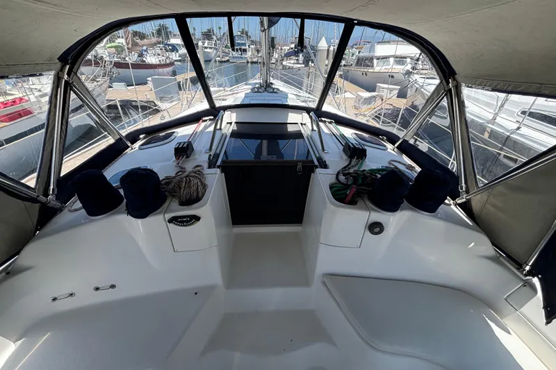 Slide: The Image of Cockpit view of 1999 Hunter 410 sailboat docked at marina, featuring ropes and equipment. - 24