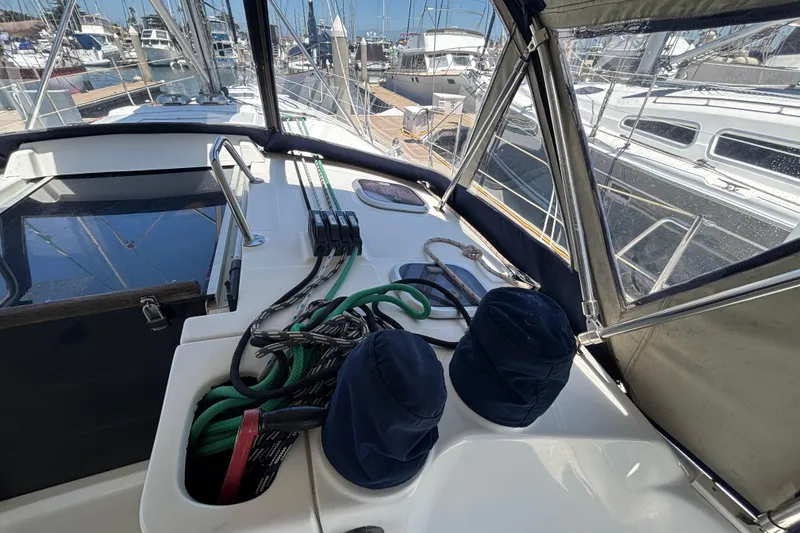 Slide: The Image of Cockpit of a 1999 Hunter 410 sailboat with ropes and marina view. - 26
