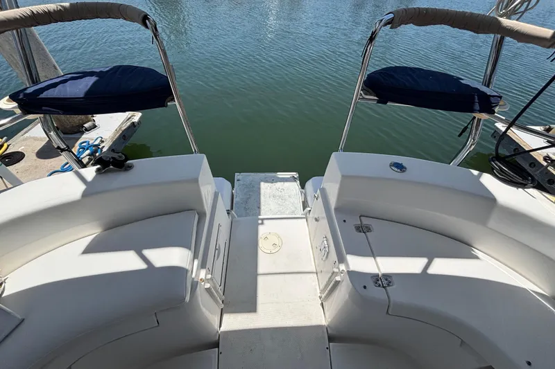 Slide: The Image of 1999 Hunter 410 yacht stern view with seating, overlooking calm water. - 27