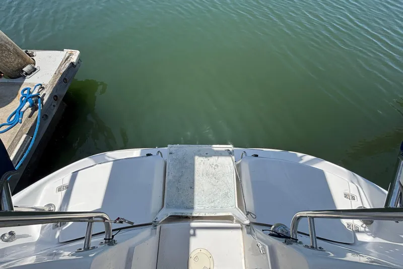Slide: The Image of Stern view of 1999 Hunter 410 boat docked on calm water. - 28