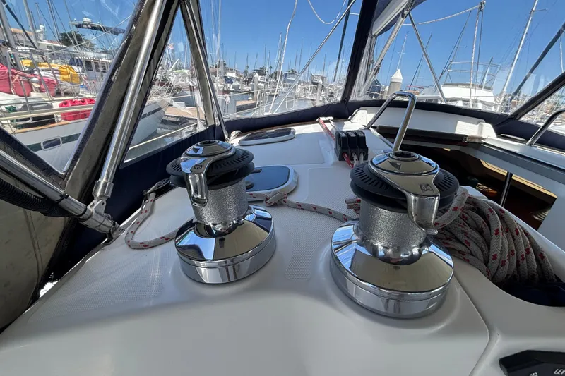 Slide: The Image of Hunter 410 sailboat deck with winches and ropes, docked in a marina, 1999 model. - 29