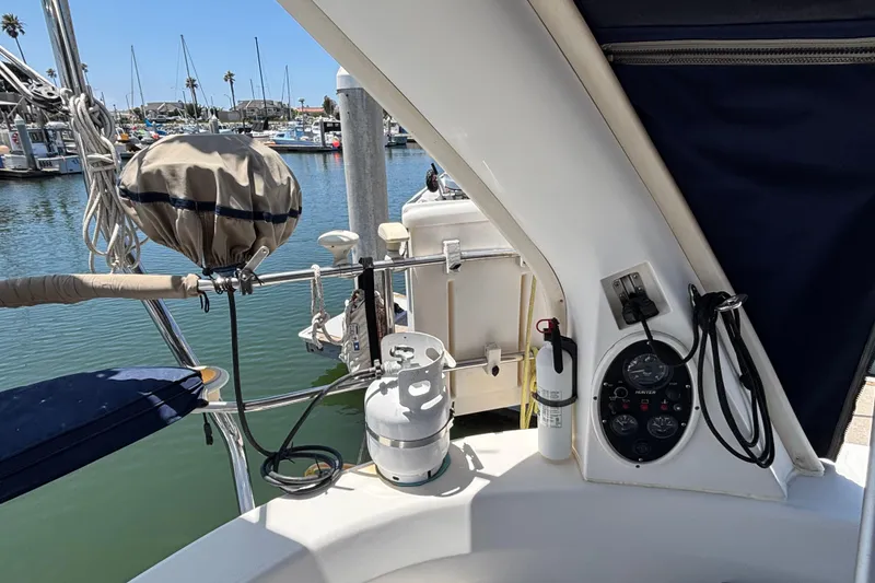 Slide: The Image of Cockpit of a 1999 Hunter 410 sailboat with control panel and safety equipment. - 31