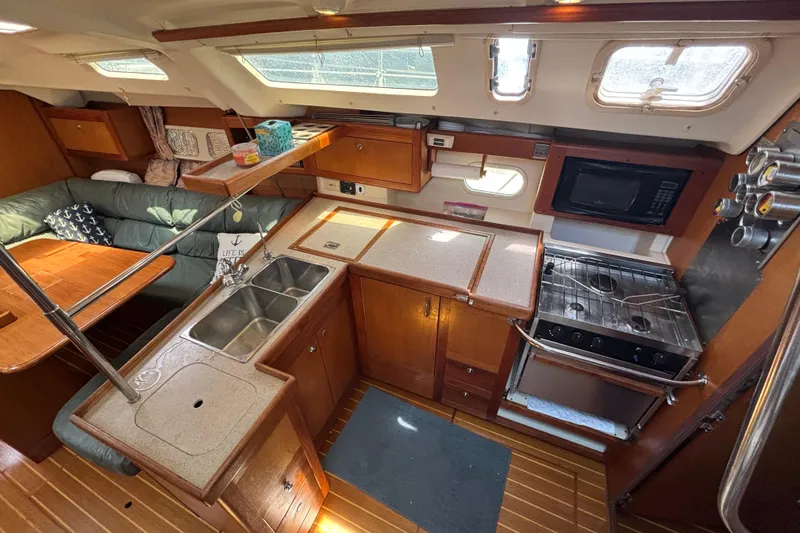 Slide: The Image of Interior of 1999 Hunter 410 yacht kitchen with wooden cabinetry and modern appliances. - 35