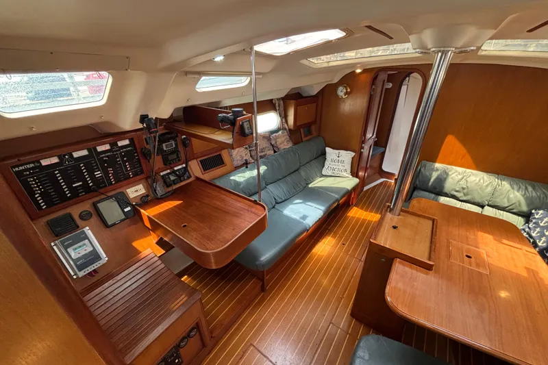 Slide: The Image of Interior of a 1999 Hunter 410 sailboat with wood finish and navigation equipment. - 36