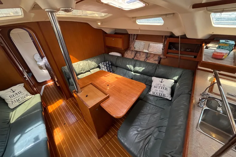 Slide: The Image of Interior of 1999 Hunter 410 sailboat with cozy seating and wooden table. - 37