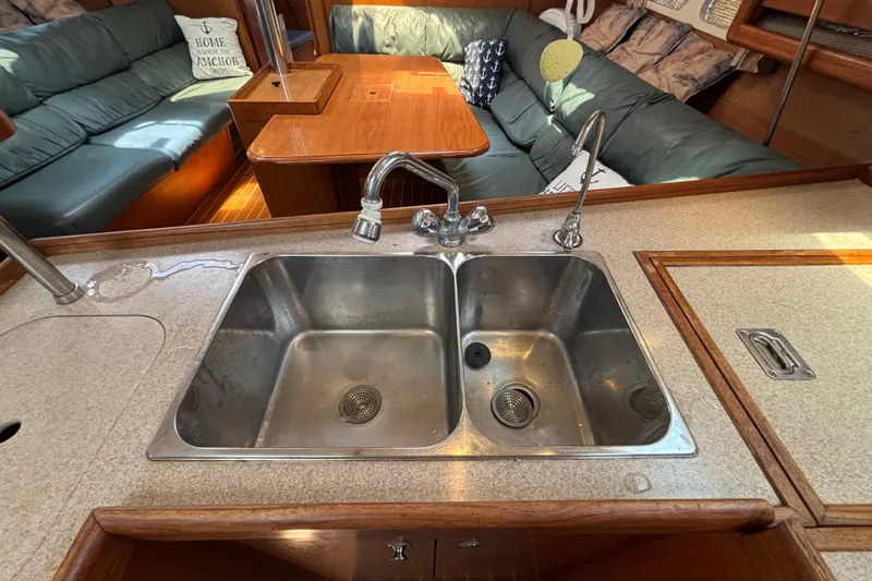 Slide: The Image of Interior of 1999 Hunter 410 yacht with dual sink and cozy seating area. - 39