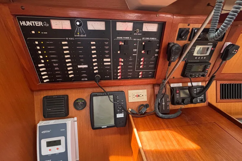 Slide: The Image of Control panel of a 1999 Hunter 410 sailboat with navigation and communication equipment. - 44