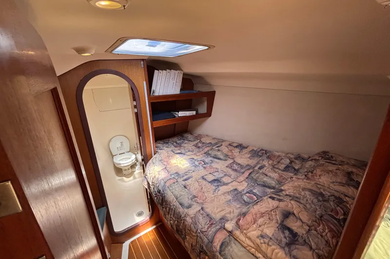 Slide: The Image of Cozy cabin interior of 1999 Hunter 410 sailboat with bed and compact bathroom. - 47