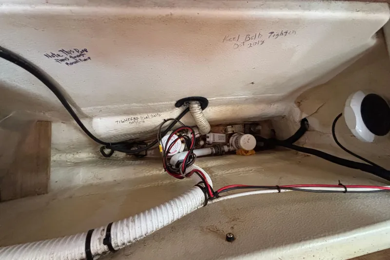 Slide: The Image of Interior view of a 1999 Hunter 410 sailboat showing wiring and keel bolt notes. - 55