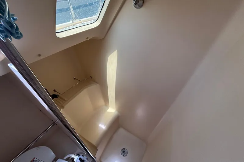 Slide: The Image of Interior of a 1999 Hunter 410 sailboat bathroom with shower and skylight. - 58