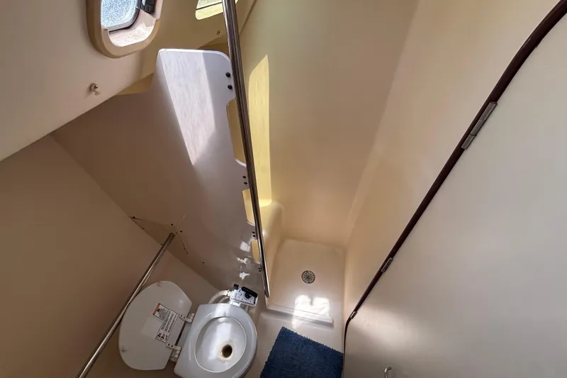 Slide: The Image of Bathroom interior of 1999 Hunter 410 yacht, featuring toilet and shower area. - 59