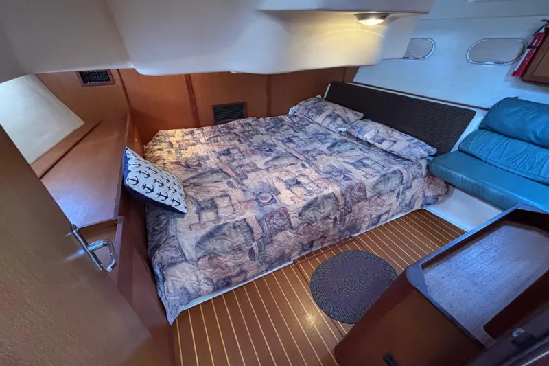 Slide: The Image of Cozy cabin interior of 1999 Hunter 410 sailboat with bed and seating area. - 60