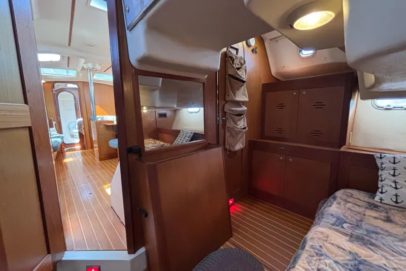 Slide: The Image of Interior of a 1999 Hunter 410 sailboat with wood finish and cozy cabin layout. - 62