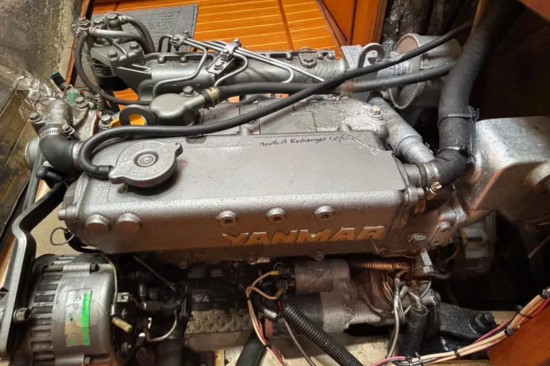 Slide: The Image of Yanmar engine in a 1999 Hunter 410 sailboat, showcasing detailed mechanical components. - 65