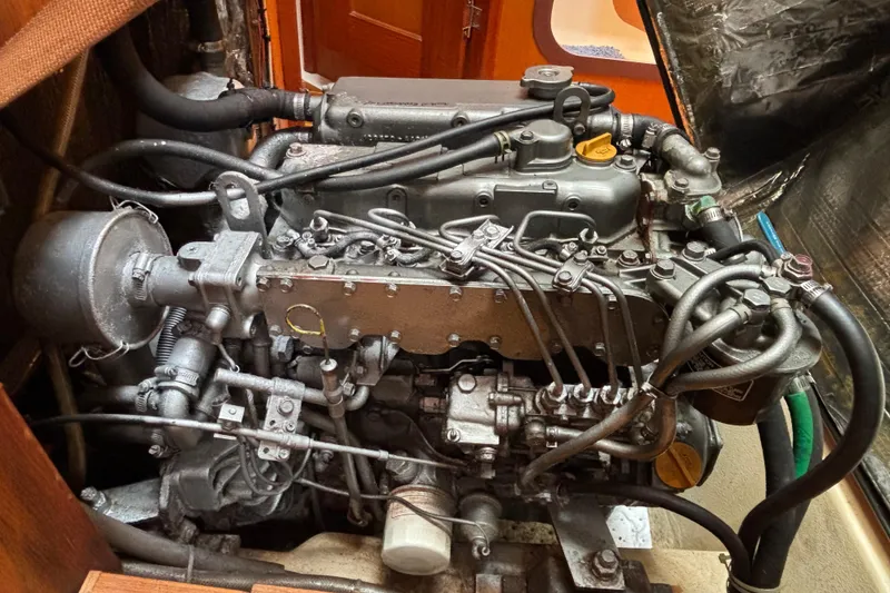 Slide: The Image of Engine of a 1999 Hunter 410 sailboat, showcasing intricate mechanical components. - 66