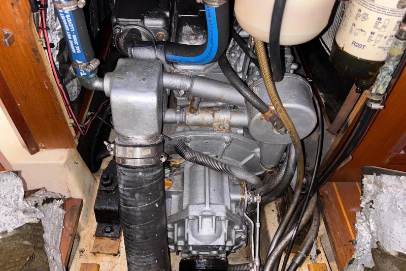 Slide: The Image of Engine compartment of a 1999 Hunter 410 sailboat, showing mechanical components and hoses. - 67