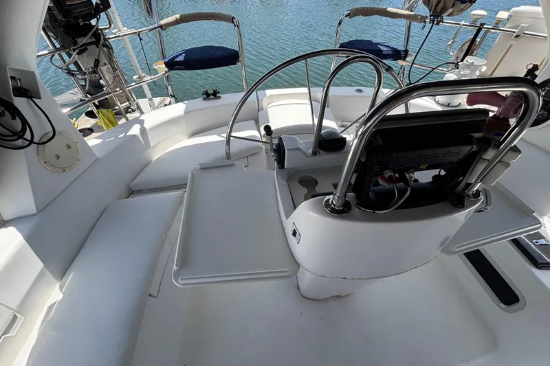 Slide: The Image of Cockpit of 1999 Hunter 410 sailboat with steering wheel and seating, overlooking water. - 68