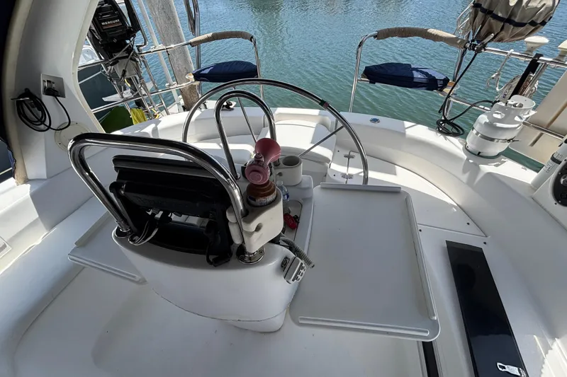 Slide: The Image of Cockpit of 1999 Hunter 410 sailboat with steering wheel and controls. - 69