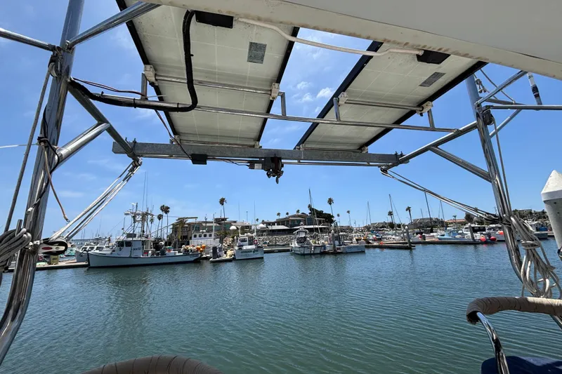 Slide: The Image of View from a 1999 Hunter 410 sailboat overlooking a marina with docked boats. - 70