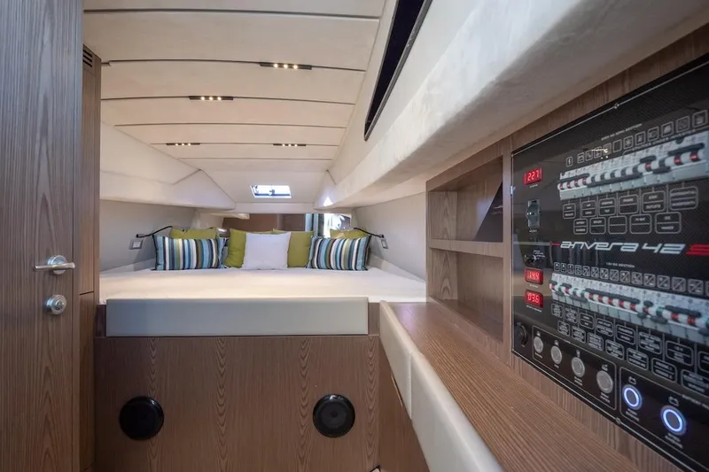 Slide: The Image of Interior of 2025 Anvera 42 yacht, featuring a cozy cabin with modern control panel. - 11
