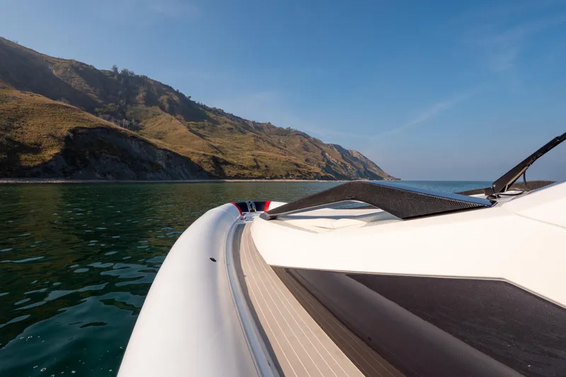 Slide: The Image of 2025 Anvera 42 yacht cruising near scenic coastal cliffs under clear blue skies. - 12