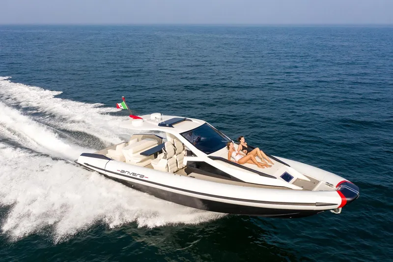 Slide: The Image of 2025 Anvera 42 yacht cruising on open sea with passengers relaxing on deck. - 2