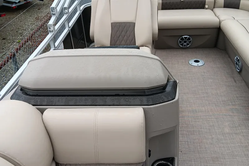 Slide: The Image of 2025 Sun Tracker Party Barge 20 DLX interior with beige seating and carpeted flooring. - 12
