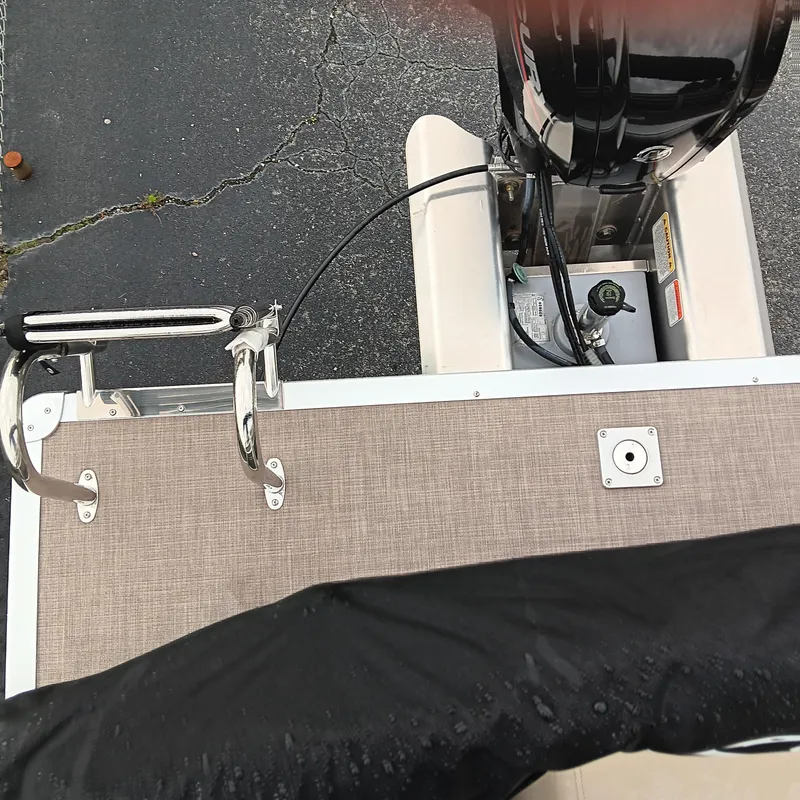 Slide: The Image of 2025 Sun Tracker Party Barge 20 DLX boat deck with motor and railing. - 13